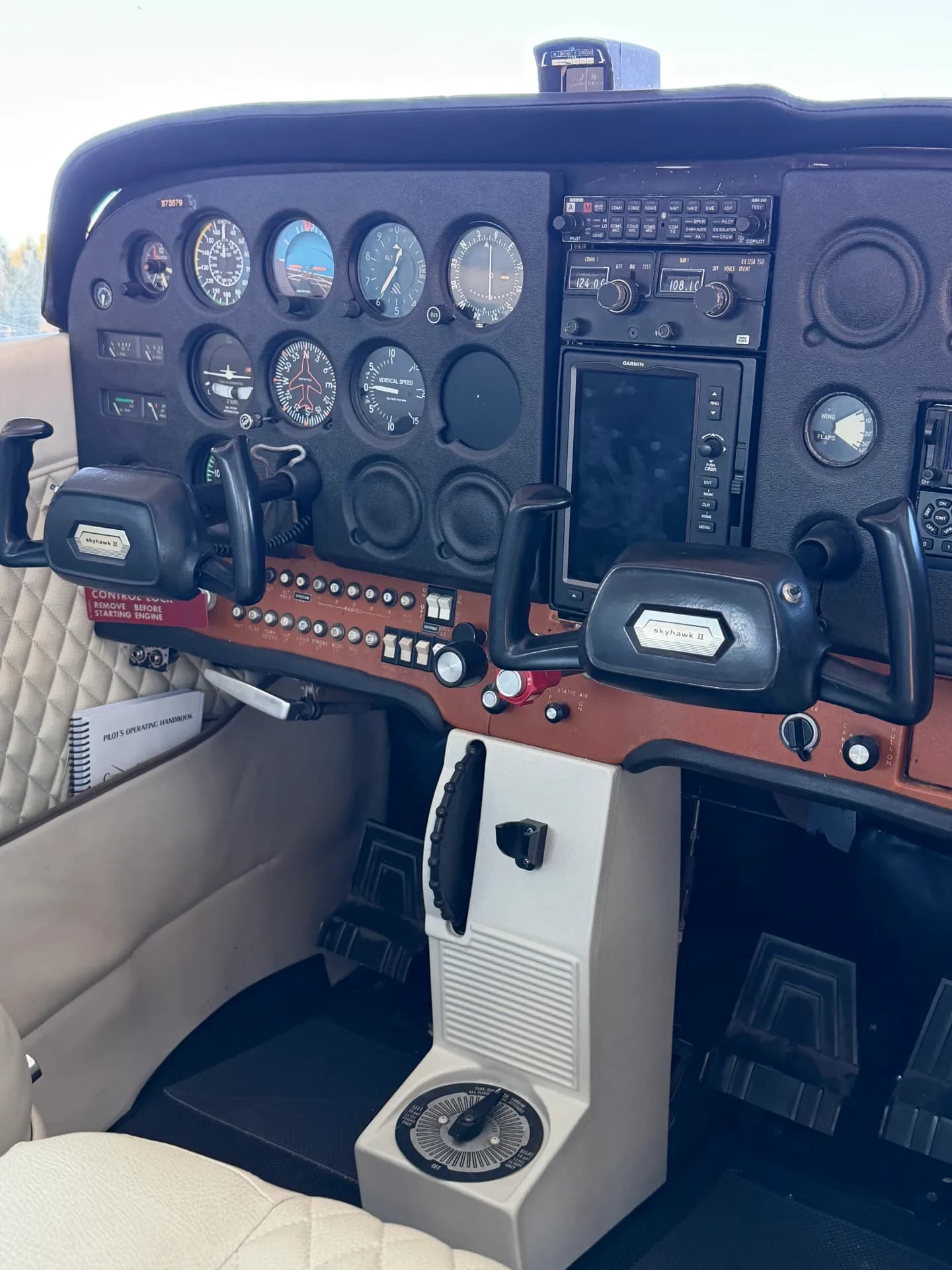 Cessna 172M full instrument panel showing dual yokes and radio stack