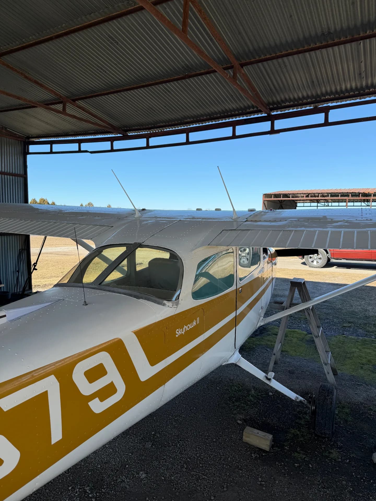 Cessna 172M rear quarter view showing N73579 registration and Skyhawk II badge under hangar